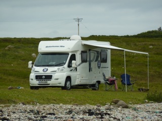 Wild camp spot with picnic equipment and awning out