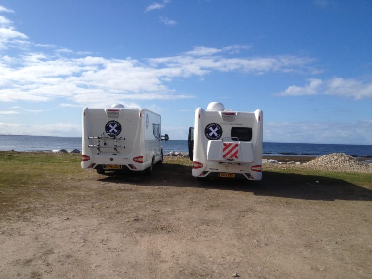 pair of motorhomes parked looking at the sea in Scotland