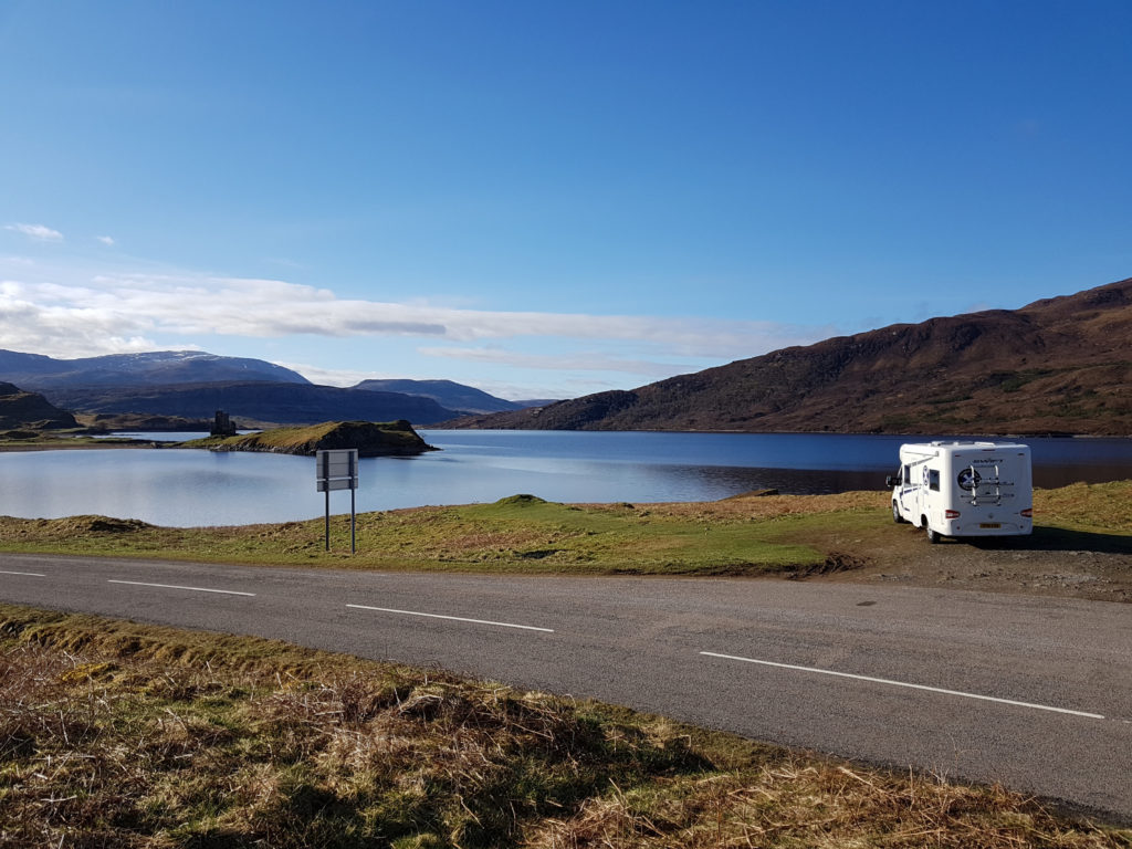 Motorhome parked by loch side