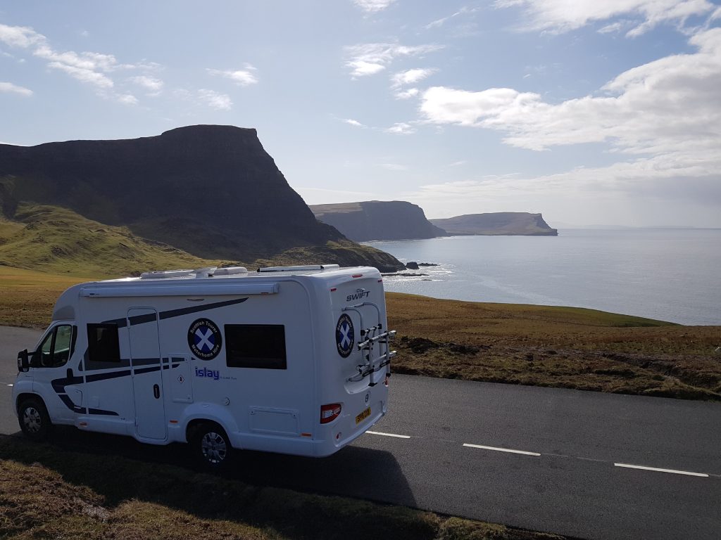 Motorhome parked in layby with the view of the cliffs and the sea