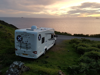 sun setting with scottish tourer wild camp spot