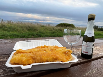 Fish supper and prosecco by the beach