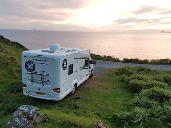 Lovely sunet with motorhome by loch