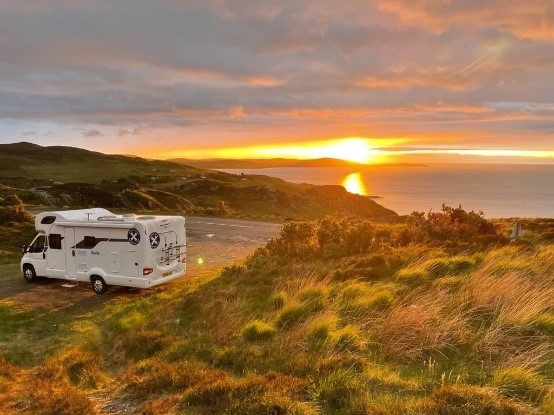 Motorhome parked up in layby with sun setting