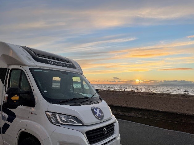 Sunsetting at the beach with motorhome in the foreground