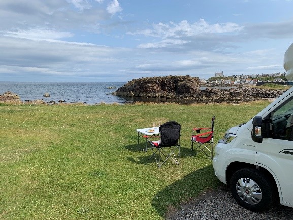 Motorhome parked with picnic furniture sitting outside