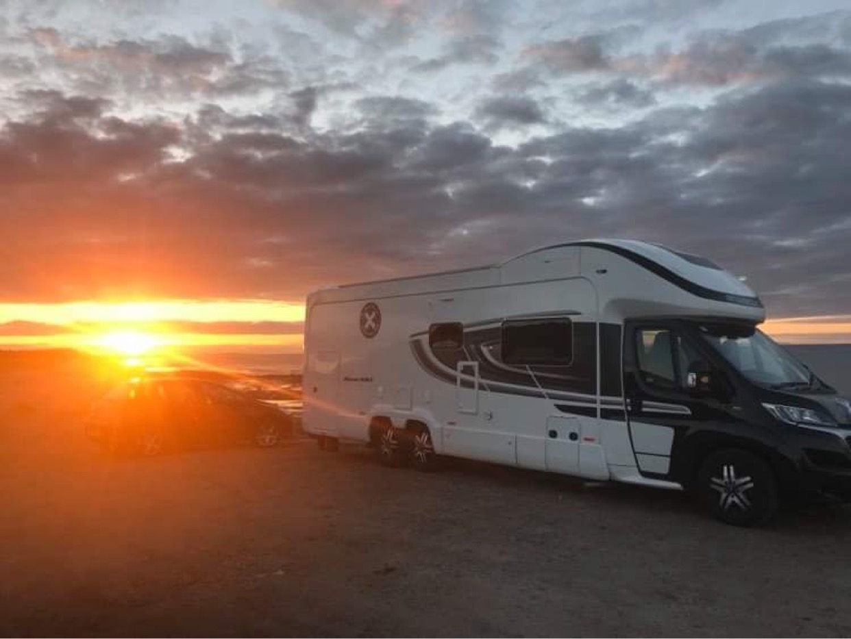 motorhome in front of sunset